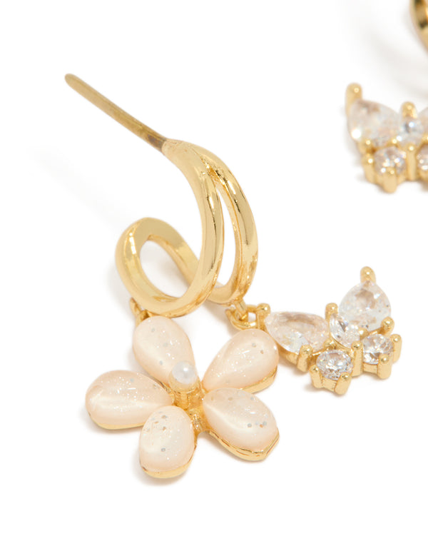 Featuring gold cubic zirconia butterfly and flower double hoop earrings with floral charms close up view