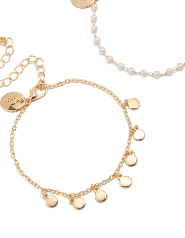 Detailed view of gold discs and pearl 2-pack bracelets close up view