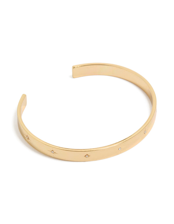 Showcasing a celestial star diamante wrist cuff crafted from gold plated material front view