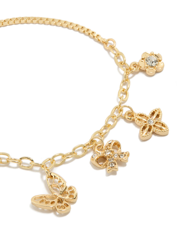 Crafted from gold plated material with diamante butterfly bow charms on a toggle bracelet close up view