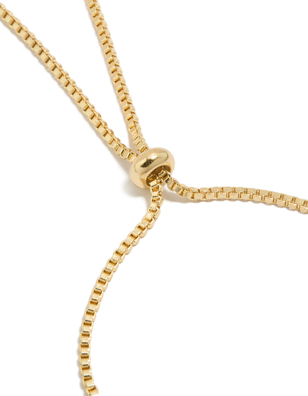 Highlighting the gold plated diamante butterfly bow charms toggle bracelet closure detail view