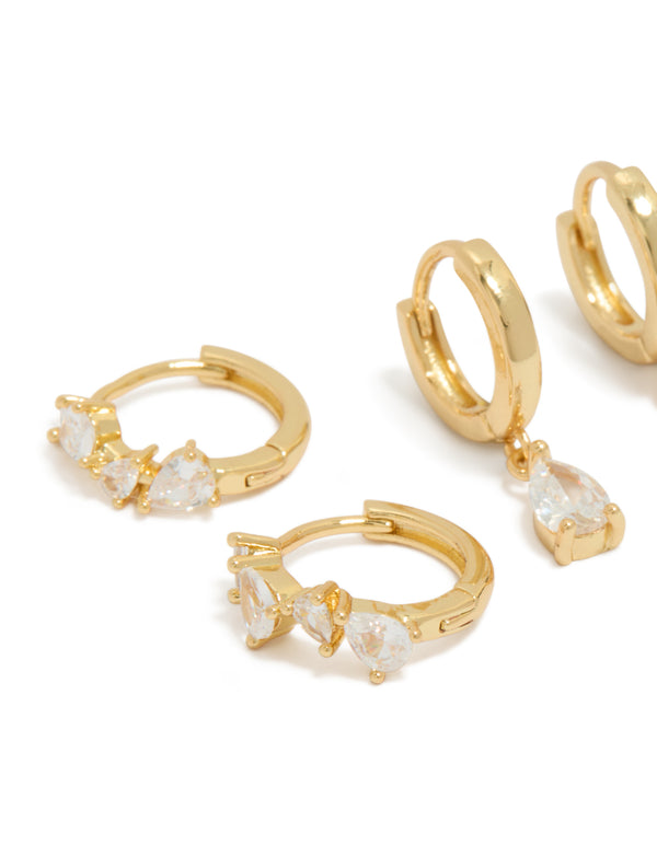 Crafted from gold plated material, these pear cut cubic zirconia huggie and stud earrings in a 3-pack feature crystal details close up view