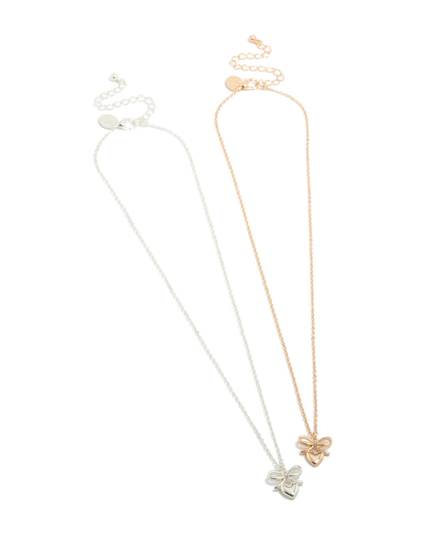 Featuring mixed metal bow and heart pendant necklaces in gold and silver 2-pack front view