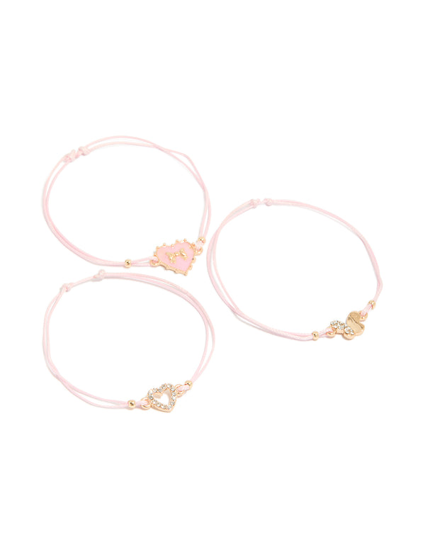 Featuring heart, bow and butterfly bracelets crafted from cord and enamel in a 3-pack with light pink and gold tones front view
