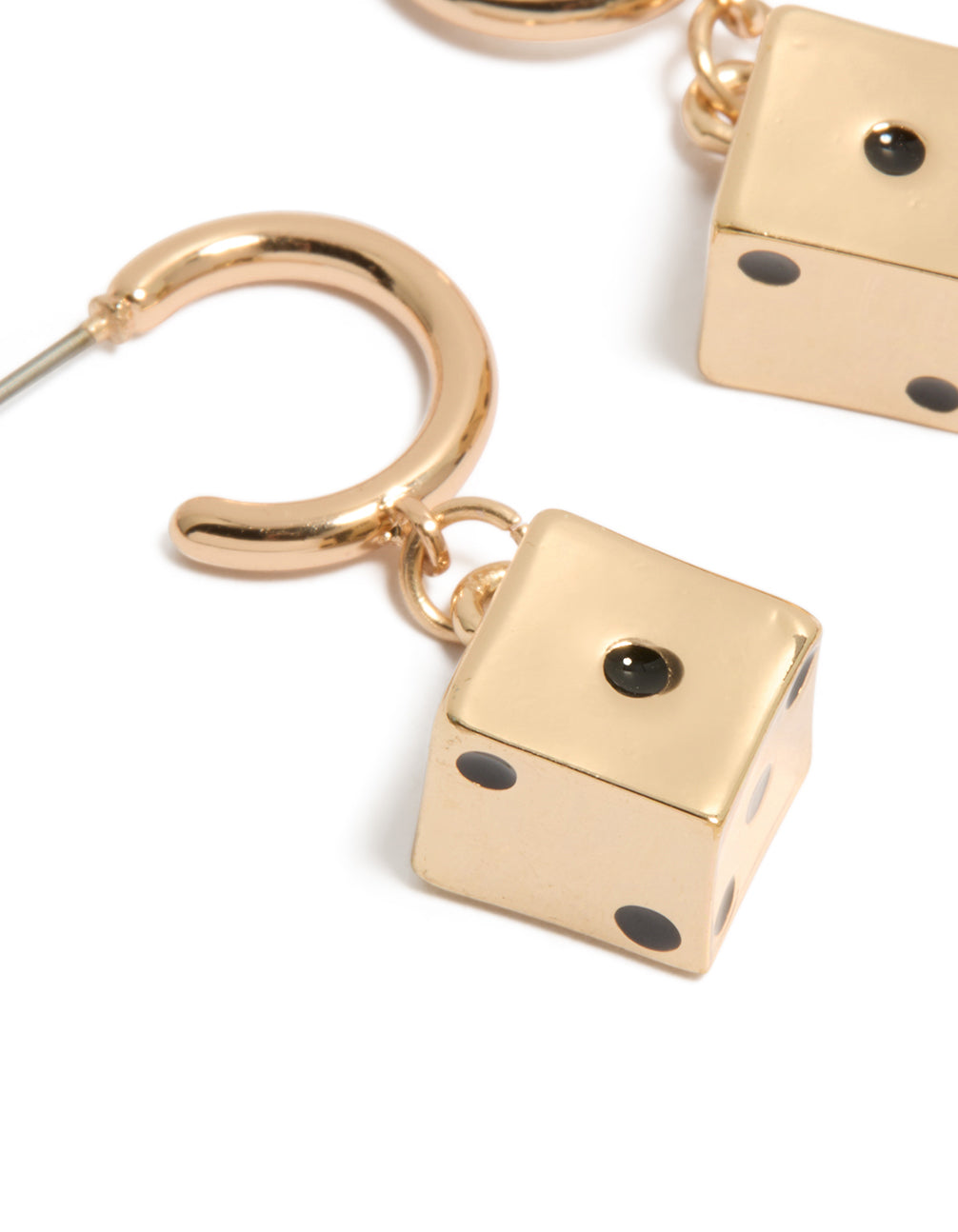 Highlighting gold dice huggie earrings with black accents in a close up view