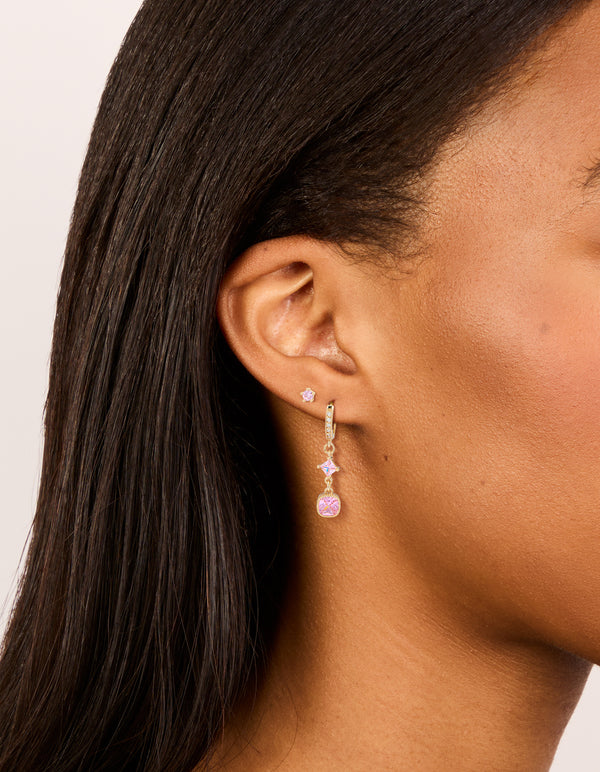 Showcasing gold pink cubic zirconia stud and huggie earrings 2-pack with charm details and crystal accents on ear view