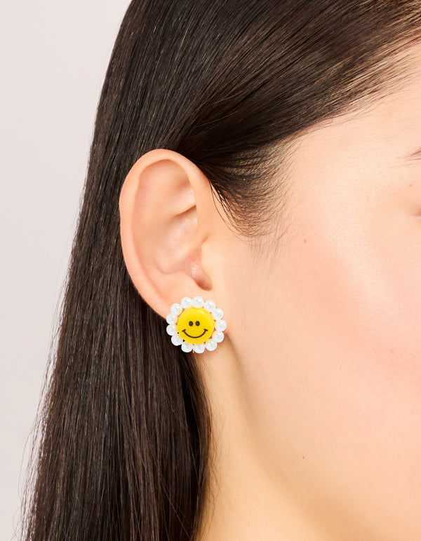 Featuring acrylic flower smiley face stud earrings with pearl accents in yellow and white on ear view