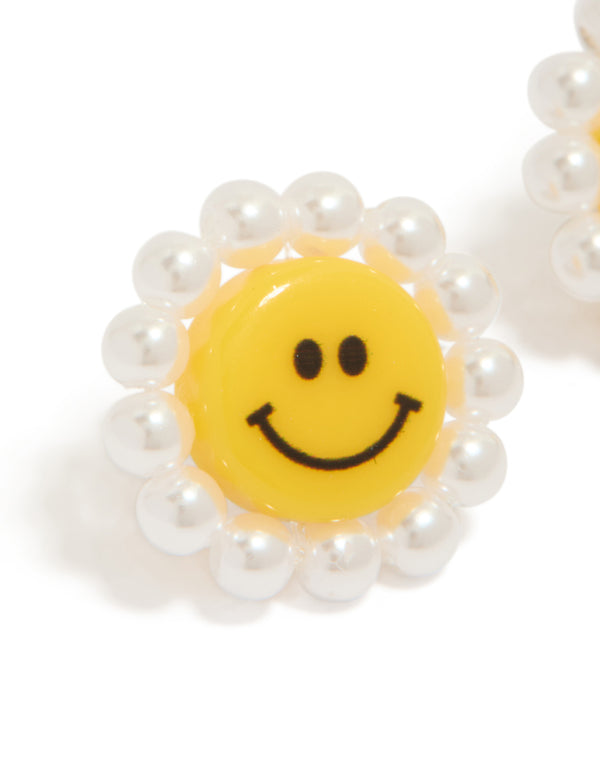 Designed with acrylic flower smiley face stud earrings featuring pearl border in yellow and white close up view