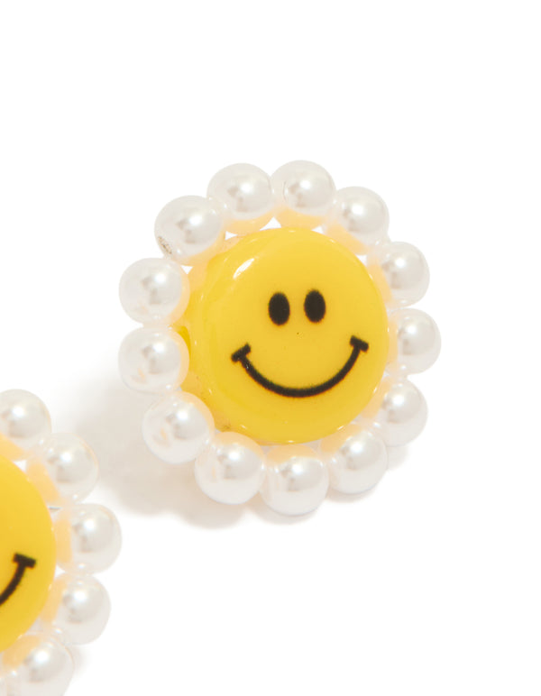 These floral stud earrings with pearl accents in yellow and white acrylic post detail view