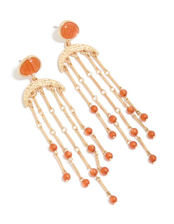 Crafted with statement style, these gold cat eye stone drop earrings feature beads and charm elements in coral and orange front view