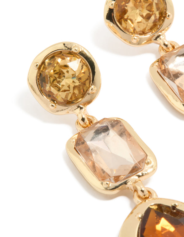 Featuring statement gold brown diamantes drop earrings with faceted stone settings close up view
