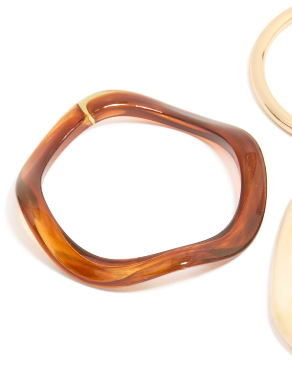 Crafted from resin, thin bangle in gold tones close up view