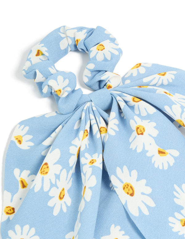 Featuring a sky blue daisy printed scarf scrunchie with floral print in white and yellow side view