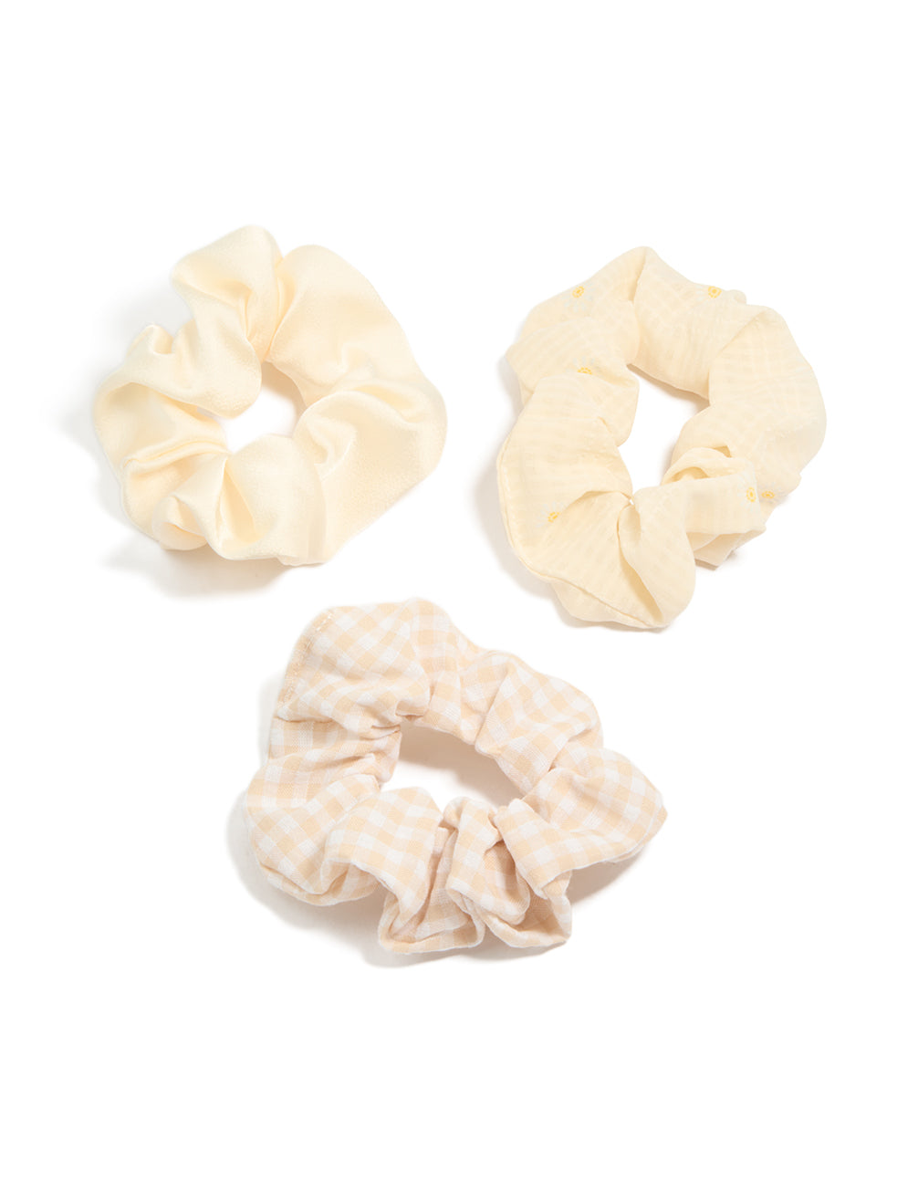 Showcasing a floral checkered 3-pack of cream, white, and yellow scrunchies front view