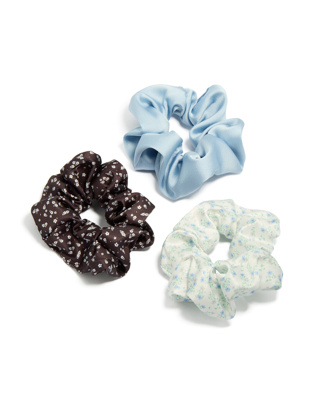 Featuring a floral print, this brown and blue mixed fabric scrunchies 3-pack in light blue, ivory, and powder blue tones front view