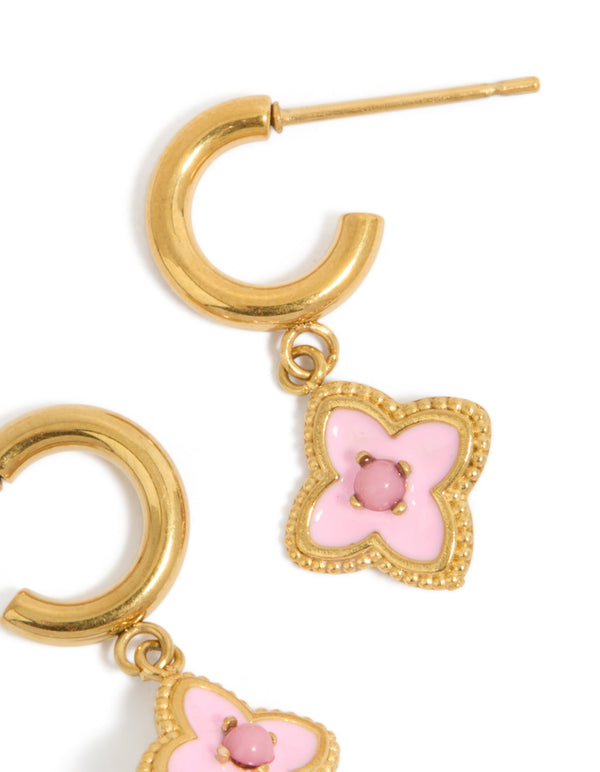 Highlighting floral charm hoop earrings in gold plated stainless steel with pink enamel petal details close up view
