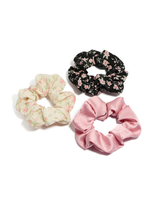 Showcasing tweens pink and cream floral scrunchies with leaf accents in a 3-pack front view