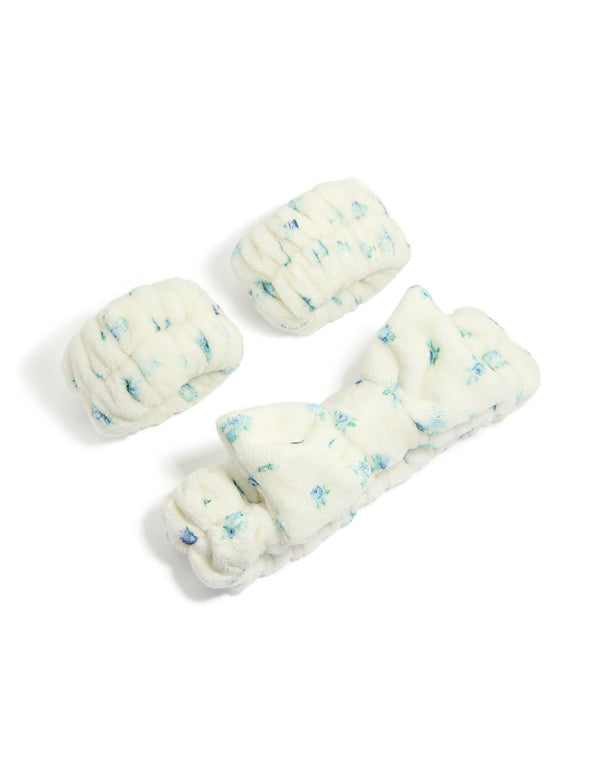 Featuring a bow and floral print in ivory, skyblue, and teal, this tweens wristband and fabric headband set front view