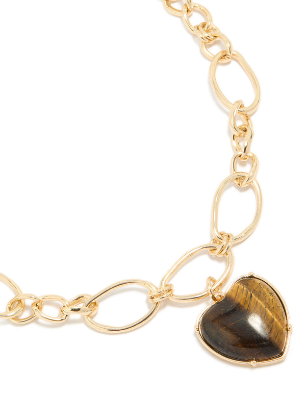 Showcasing a gold loop chain necklace with brown heart pendant close up view