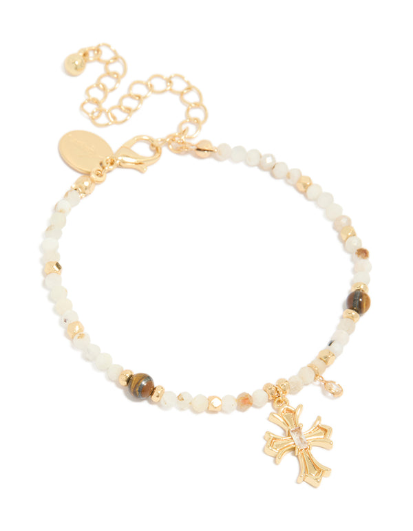 Showcasing a gold plated beaded bracelet with cross charm featuring cubic zirconia crystal accents front view