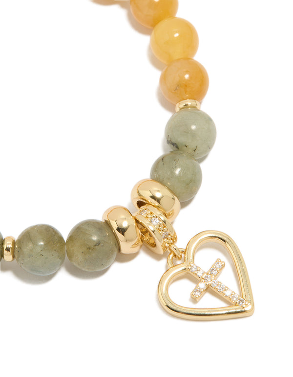 Featuring a gold plated beaded bracelet with cross and heart in cubic zirconia, chunky statement design close up view
