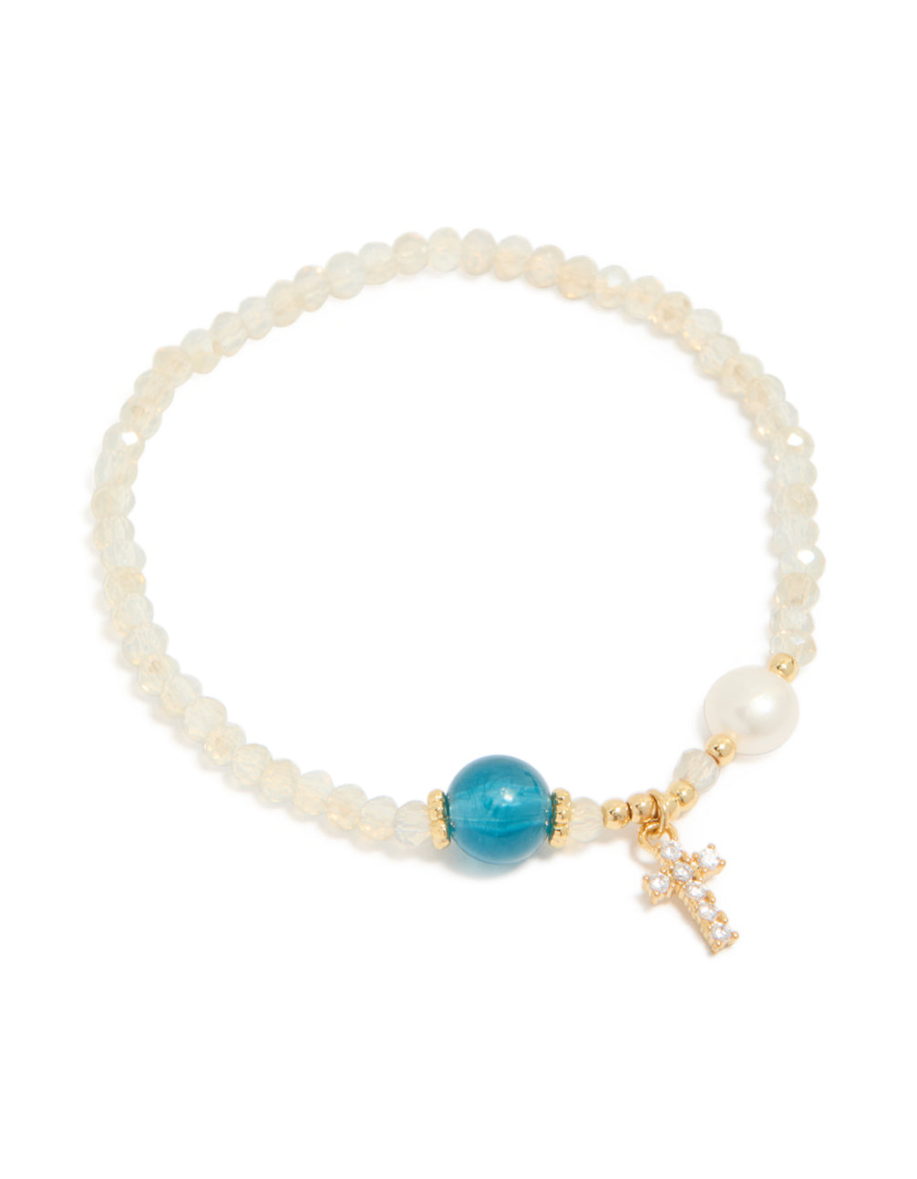 Crafted from gold plated metal, this dainty beaded bracelet features a cross charm with cubic zirconia, freshwater pearl accents, and turquoise beige white details front view