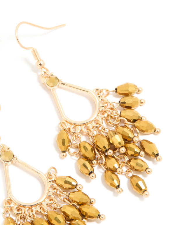 Crafted from gold with statement irregular beaded drop earrings and charm post details view