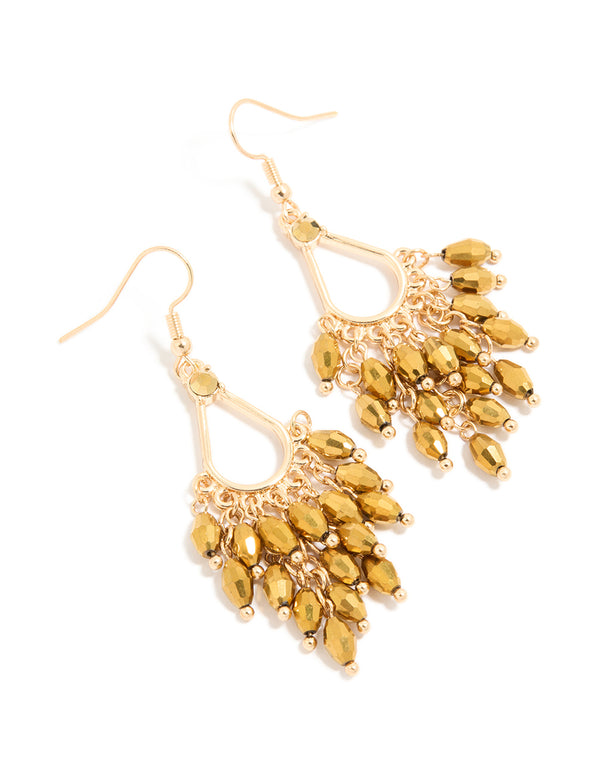 Showcasing statement drop earrings featuring irregular beaded charms in gold front view