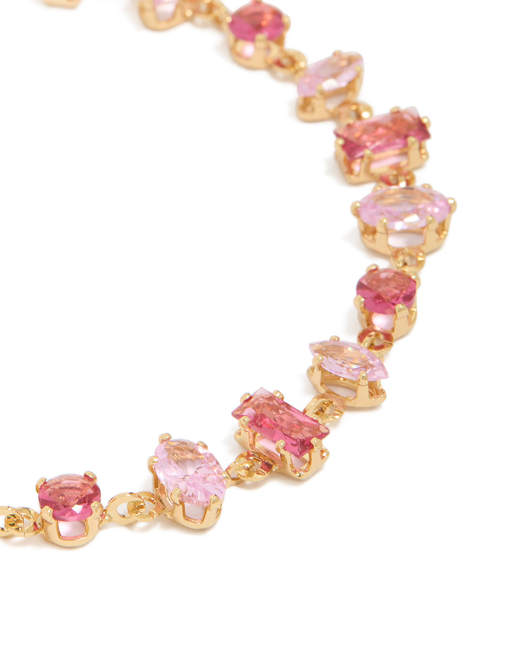 Detailed view of gold large pink multi-cut cubic zirconia bracelet highlighting hot colored stone settings and prong detail close up view
