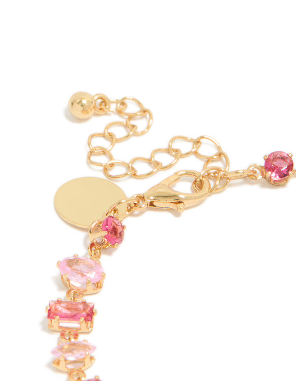 Showcasing gold large pink multi-cut cubic zirconia tennis bracelet with adjustable chain closure detail view