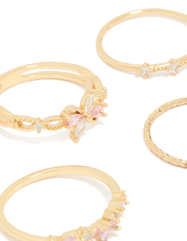 Detailed view of gold pink and clear cubic zirconia flower rings 5-pack with butterfly featuring crystal in white close up view