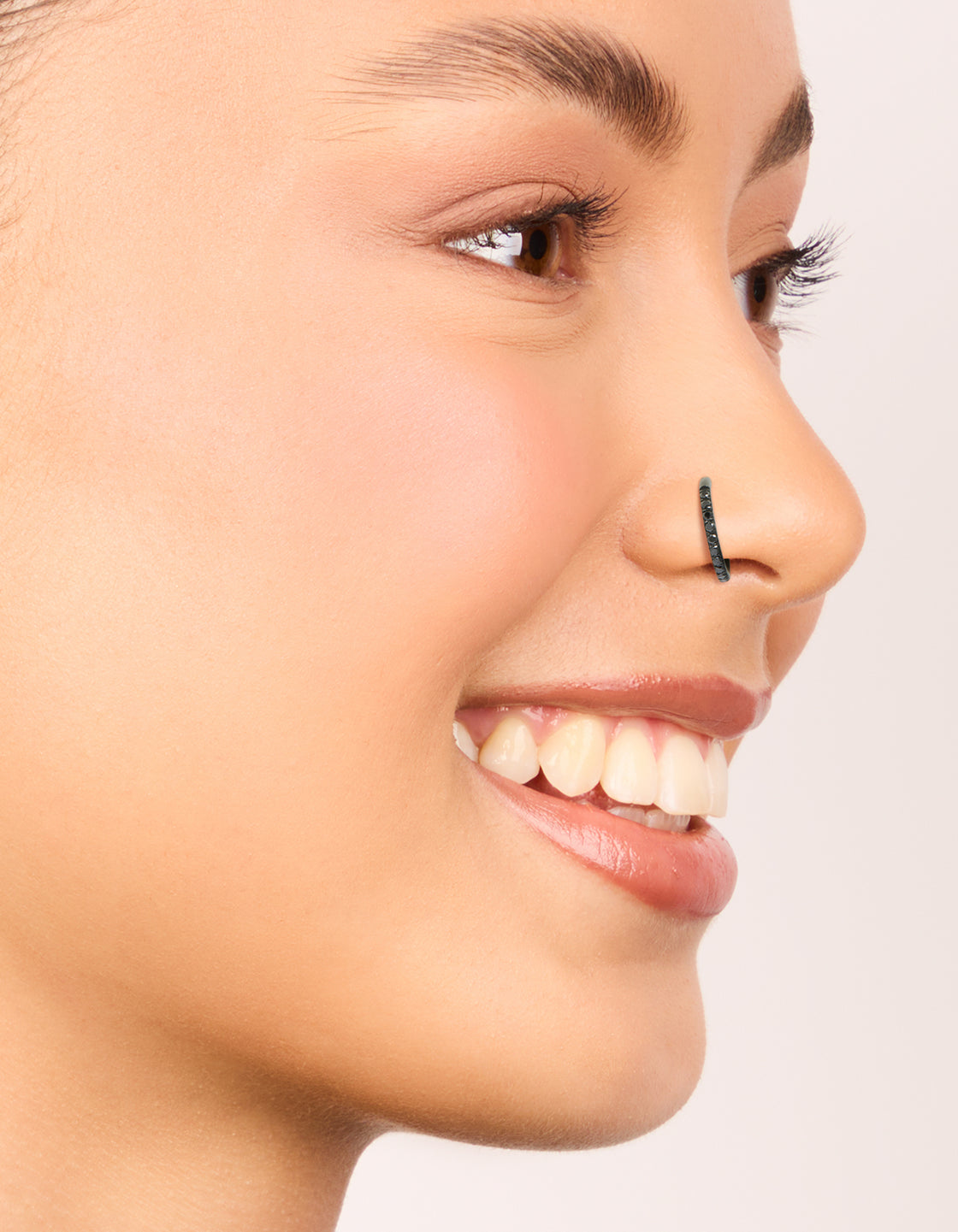 Black coated surgical steel cubic zirconia hinged nose rings pack in grey nose view