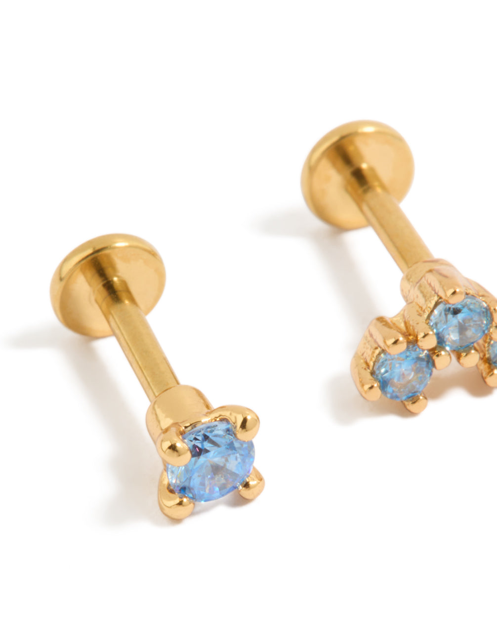 Crafted from gold plated titanium blue cubic zirconia flat back studs with crystal details and light blue stones close up view