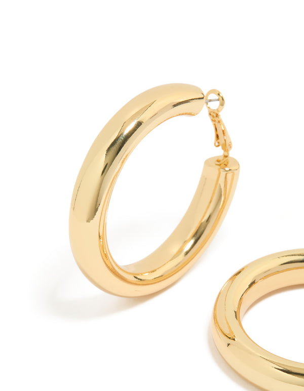 Featuring gold plated thick hoop earrings with chunky design close up view