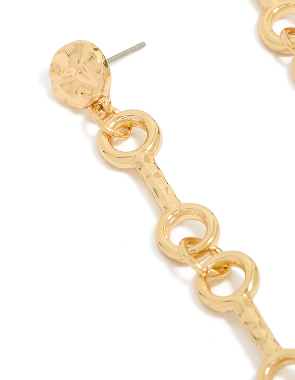 Showcasing gold plated molten chain long drop statement earrings with textured stud detail close up view