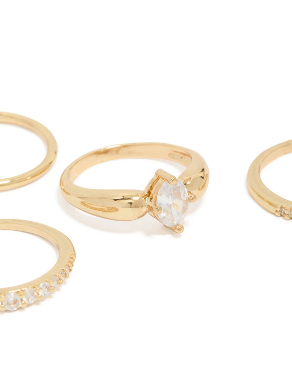 Beautifully crafted gold plated bezel set cubic zirconia band rings 4-pack with oval cut crystal stones close up view
