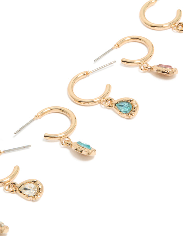 Featuring gold blue and pink diamante huggie earrings in a 3-pack with hoop closure close up view