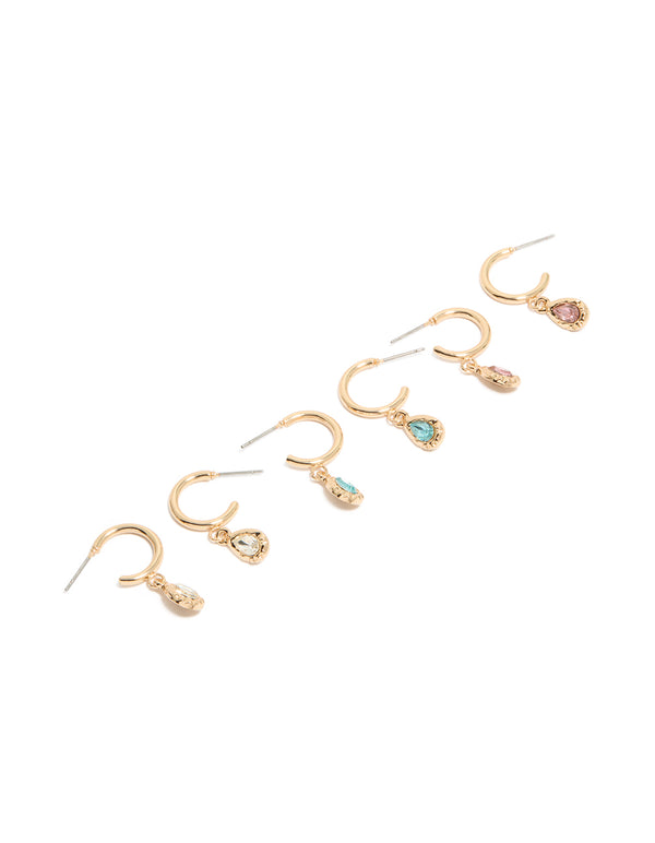 Showcasing a set of gold blue and pink diamante huggie earrings in a 3-pack with huggie closure front view