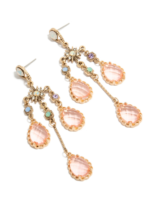 Showcasing statement stud closure diamante irregular long drop earrings featuring celestial charm designs in gold and pink front view