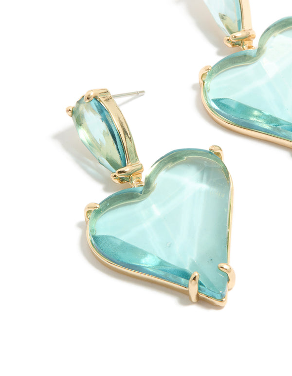 Presenting statement heart drop earrings crafted from glass stone in blue and gold tones close up view