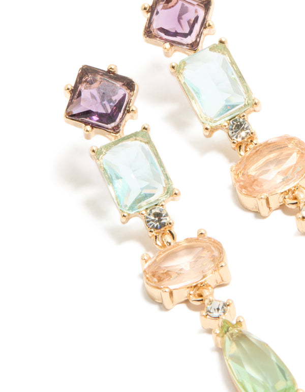 Crafted from gold, these irregular shaped purple and blue diamantes drop earrings feature oval stone cut in a statement style close up view