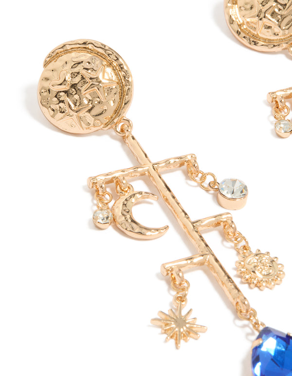 Showcasing worn gold sun and moon marble drop earrings with celestial charm details in statement style close up view