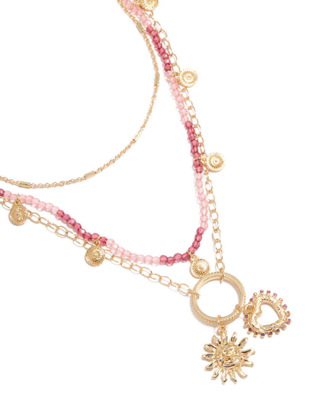 Showcasing a gold pink beaded and celestial layered necklace with charm featuring sun and heart in a statement design close up view