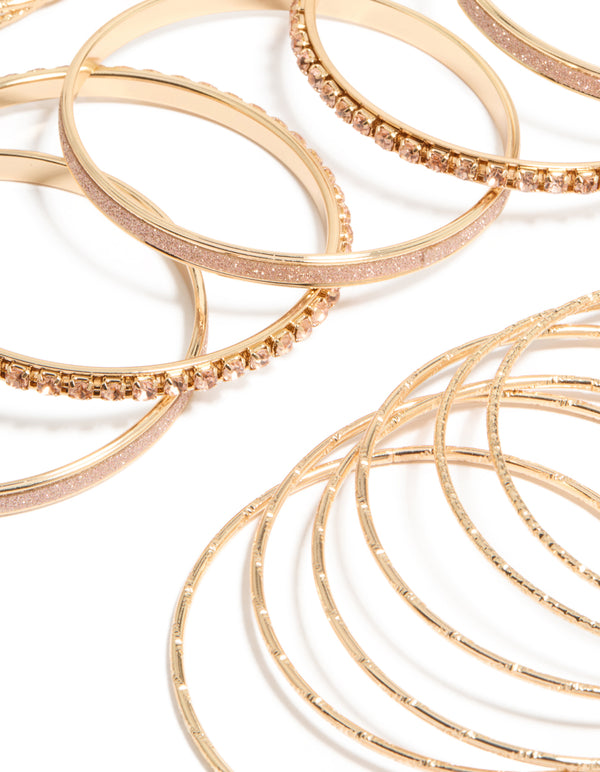 Showcasing gold pink diamante bangles in a stackable 21-pack, close up view