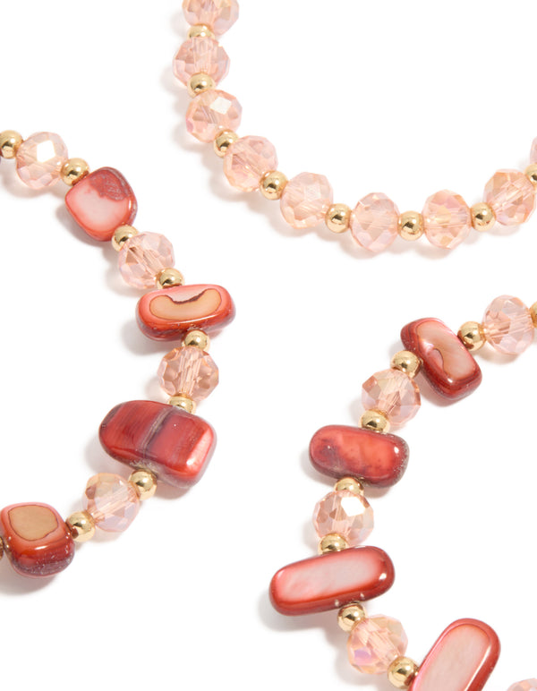 Discover beaded stretch bracelets with shell accents in light coral, light pink, and gold as a 3-pack close up view