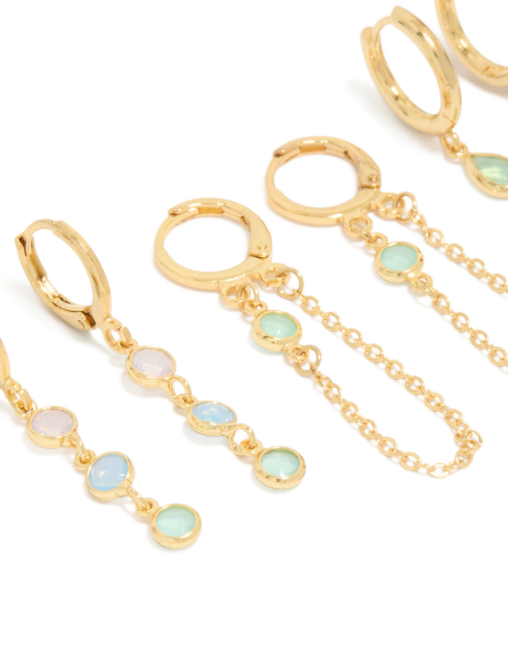 Featuring dainty stacker earrings crafted from gold plated cubic zirconia with crystal accents in lilac and blue, designed with huggie and stud closures as a 4-pack close up view