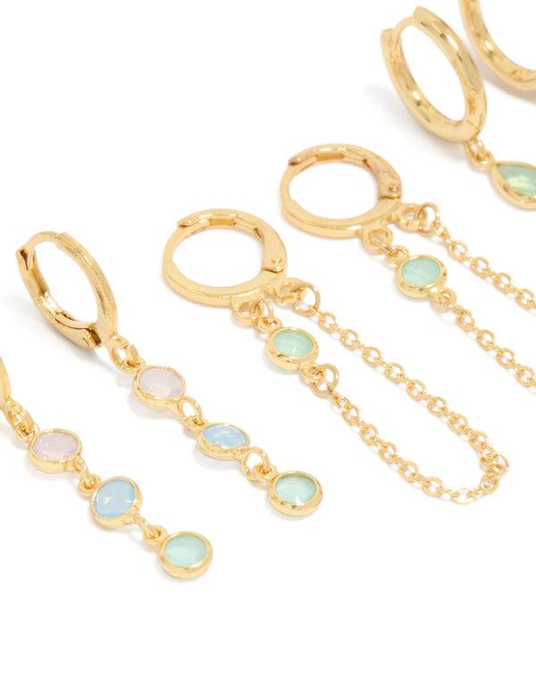 Featuring dainty stacker earrings crafted from gold plated cubic zirconia with crystal accents in lilac and blue, designed with huggie and stud closures as a 4-pack close up view