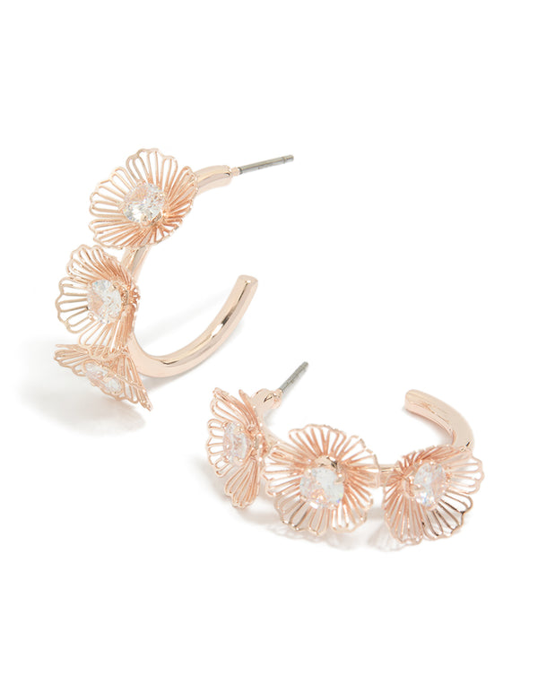 Showcasing laser cut floral hoop earrings featuring rose gold plated finish front view
