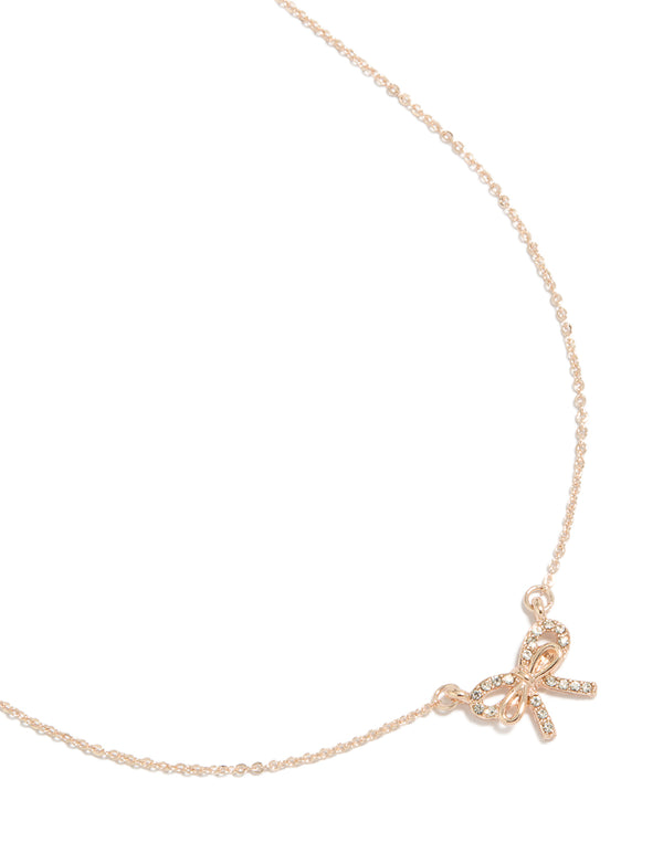 Showcasing a rose gold dainty diamante bow pendant necklace front view