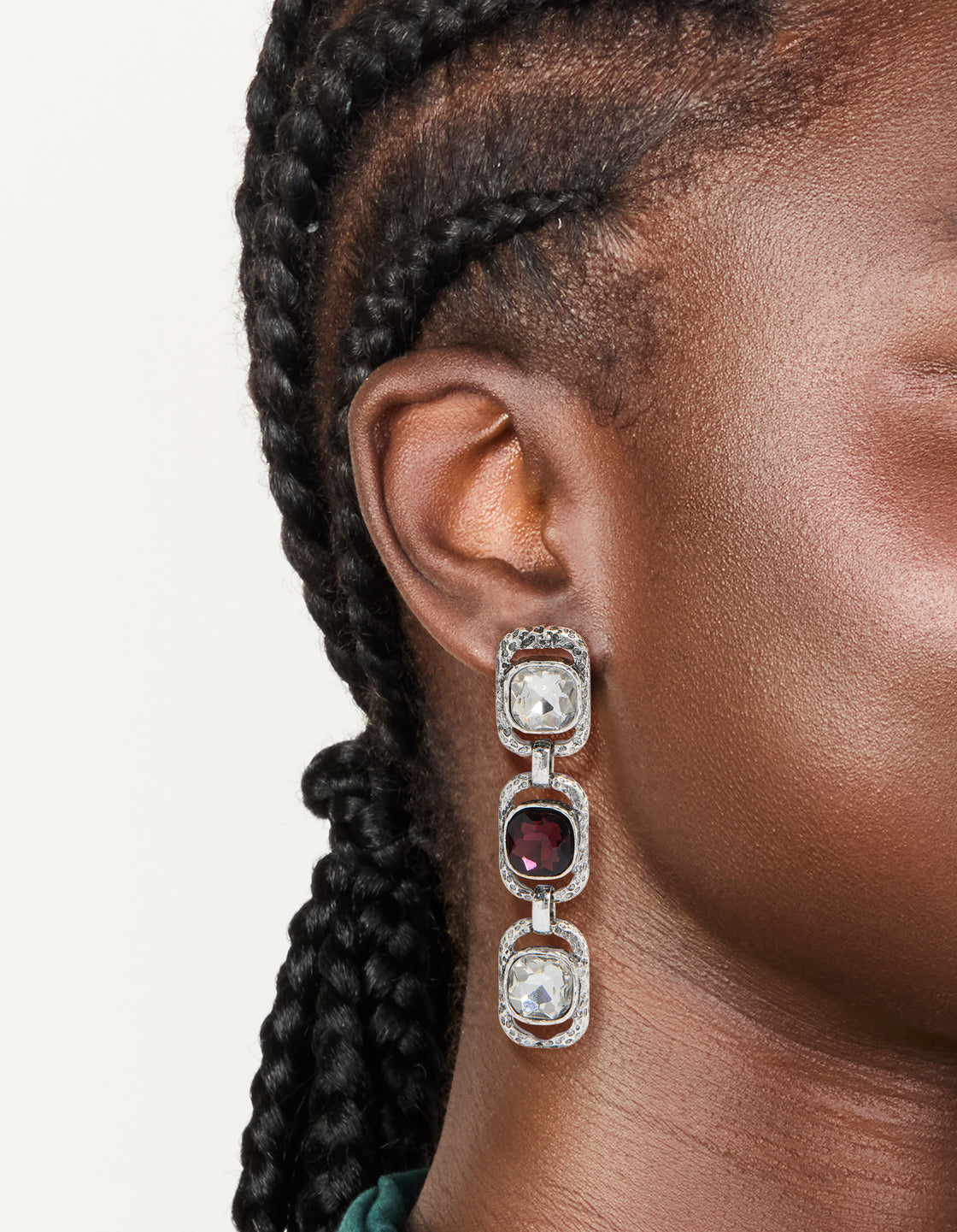 Featuring chunky statement drop earrings in silver with burgundy and clear diamante stones on ear view